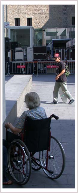 An image of a woman who is a wheelchair user and a man with a skateboard 