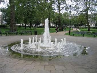A fountain in the middle of footpaths and good positioned seating